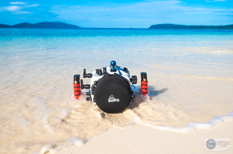 The Sony a7r V on a white sandy beach in Raja Ampat, Indonesia in an Ikelite A7R V Housing.
